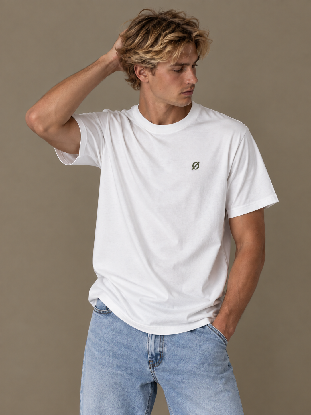 NØMADZ white men's T-shirt with olive green logo worn by a model