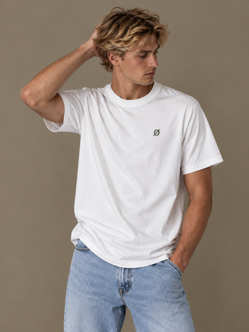 NØMADZ white men's T-shirt with olive green logo worn by a model