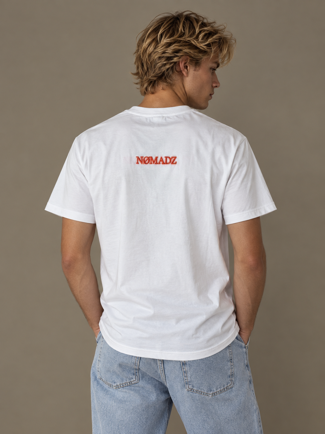 NØMADZ white men's T-shirt with orange logo on the back worn by a model