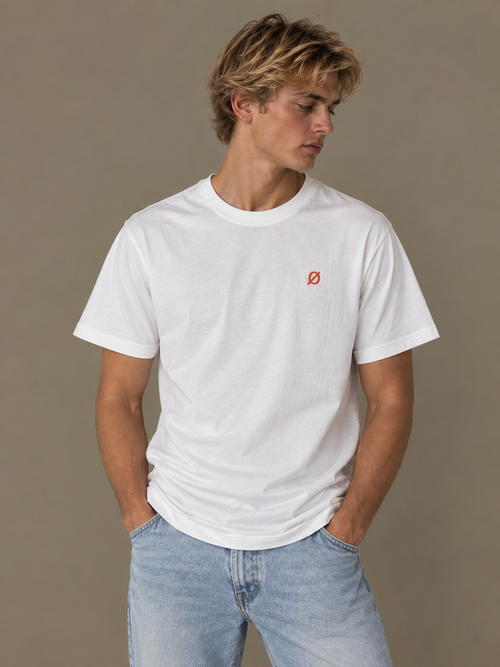 NØMADZ white men's T-shirt with orange logo worn by a model