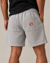 NØMADZ grey men's shorts with terracotta orange Ø embroidery on the back worn by a model