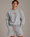 NØMADZ grey sweater and men's shorts set with orange embroidery worn by a model