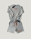 NØMADZ grey sweater and men's shorts set with orange embroidery worn by a model