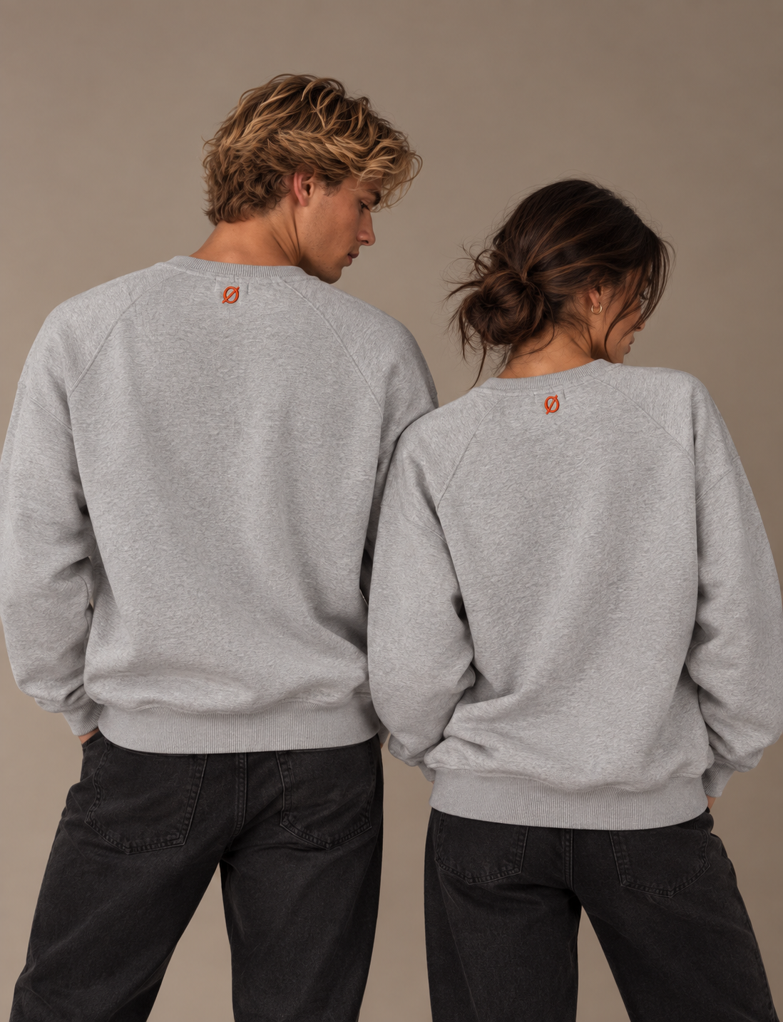 NØMADZ grey unisex sweater worn by male and female models from the back