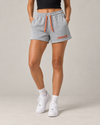 NØMADZ grey women's shorts with terracotta orange drawstring and embroidered logo worn by a model